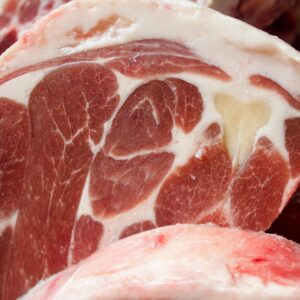 Detailed image of raw lamb chops showcasing marbling and texture. Perfect for culinary projects.